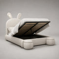 Lit coffre enfant 140 x 200 cm en similicuir blanc cassé avec tête de lit lapin, sommier relevable et 2 poufs